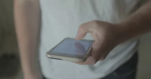 Man uses smartphone at home Stock Footage 78038055