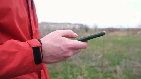 A man uses a smartphone surf the Internet on the street. Stock Footage 185705066
