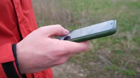 A man uses a smartphone surf the Internet on the street. Stock Footage 187778765