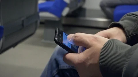 A man uses a smartphone in a train. Available internet signal Video stock 117751949