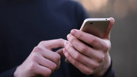 Man uses smartphone turning page Stock Footage 128970592