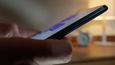 Man uses a smartphone to type messages in social networks Stock Footage 172482503