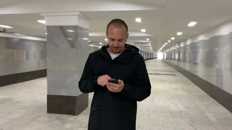 Man uses smartphone in underpass. Stock Footage 140813748