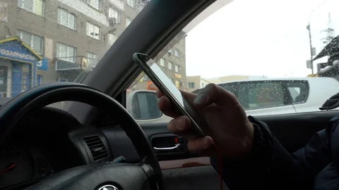 A man uses a smartphone while sitting in the car Video stock 86251211