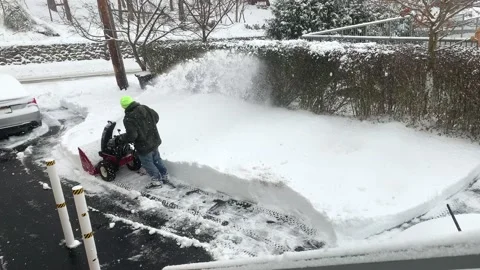 Man Uses Snow Blower Machine To Clear Snow From Driveway During Snowstorm Stock Footage 170901446