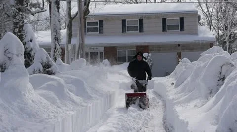 Man uses snow blower to remove snow - 1 Stock Footage 21245475