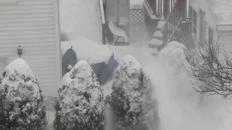Man uses snowblower, cold winter blizzard snowfall Stock Footage 80838062