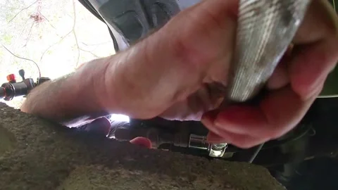Man uses a socket wrench under a car Stock Footage 142849219
