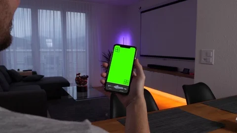 Man uses speech recognition app with greenscreen to turn on a huge screen Stock Footage 123114833