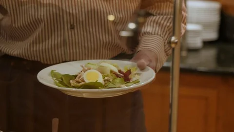 Man uses spoon to sprinkle cheese over salad at soup and salad bar european s Video stock 89203982