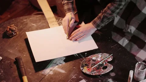 Man uses a straightedge to write a protest Slogan in a protest banner Stock Footage 143348807