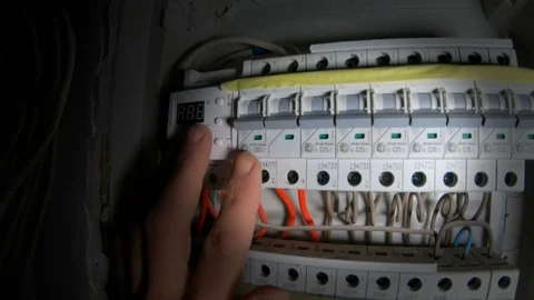 A man uses a switchboard with an electric machine. Electrical circuit breakers. Vidéo 120286175