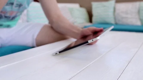 Man Uses a Tablet And Drinks Juice Stock Footage 82442528