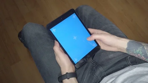 A man uses a tablet. Blue screen on tablet Stock Footage 123665698