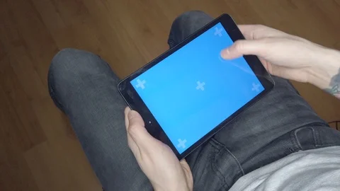 A man uses a tablet. Blue screen on tablet Video stock 123802891