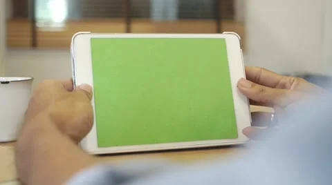 Man uses a tablet with green screen Stock Footage 65986885