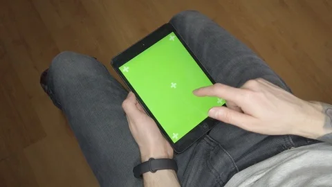 A man uses a tablet. Green screen on tablet Stock Footage 123662957