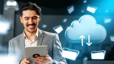 Man uses tablet to manage data with cloud technology in modern office setting Stock Photos