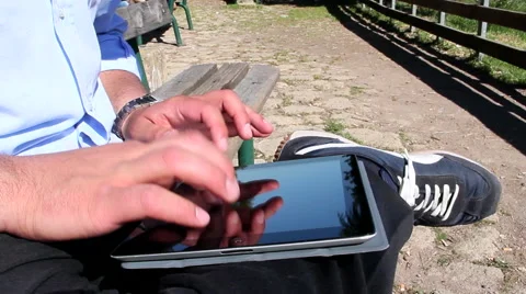 Man uses tablet outdoor Видео 42167252
