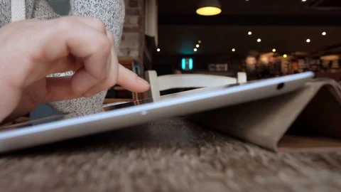 Man uses tablet PC in cafe Stock Footage 85345765