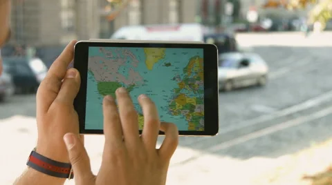 Man uses tablet pc on the street on a background sunset Stock Footage 66943103
