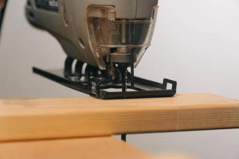 A man uses a tool to saw a tree. The concept of carpentry. Worker in a woodwo Stock Photos