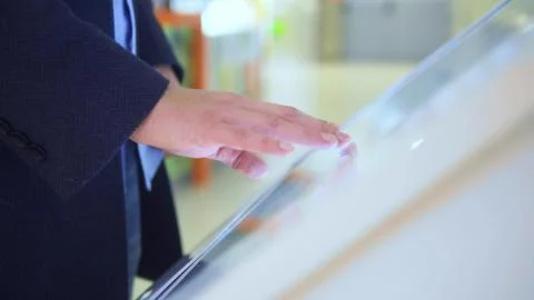 Man uses touch screen at the information Desk in the supermarket Stock Photos