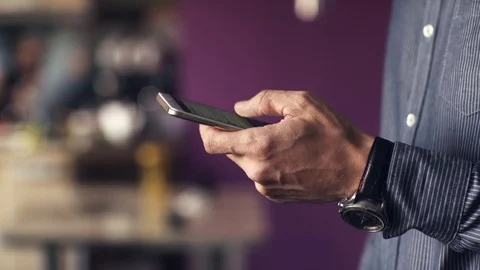 A man uses a touchscreen smartphone. Video stock 70381491