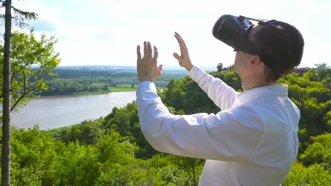 Man uses a virtual reality glasses on the roof Stock Footage 77654127