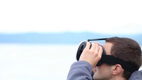 Man uses a virtual reality glasses against the sky and landscape Stock Footage 78149515