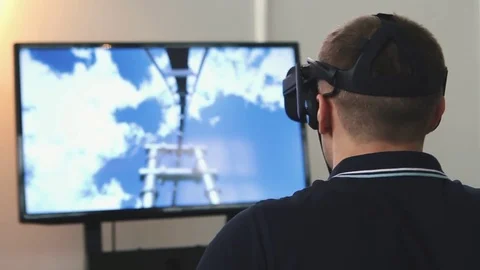 Man uses virtual reality glasses, the image on the monitor Stock Footage 82021565