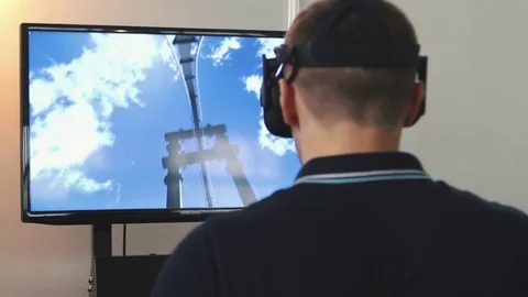 Man uses virtual reality glasses, the image on the monitor Stock Footage 82021633