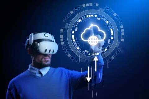 Man uses virtual reality headset to interact with digital cloud technology .. 库存照片