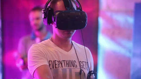 Man uses virtual reality HTC game development kit, virtual reality glasses in Stock Footage 76340987