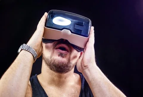 Man uses Virtual Reality VR head-mounted display with fun Stock Photos