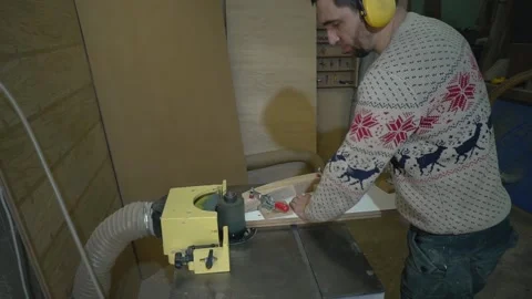 Man uses wood grinding machine Stock Footage 163423372