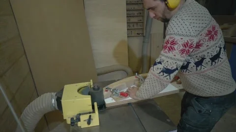 Man uses wood grinding machine Stock-Footage 163423384