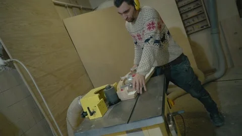 Man uses wood grinding machine Stock Footage 163423391