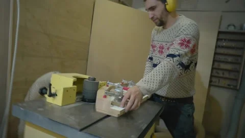 Man uses wood grinding machine Stock Footage 163423398