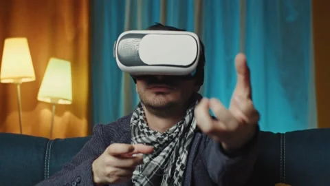 Man using 3D virtual reality headset.man wearing VR headset in living room.Man Stock Footage 169686997