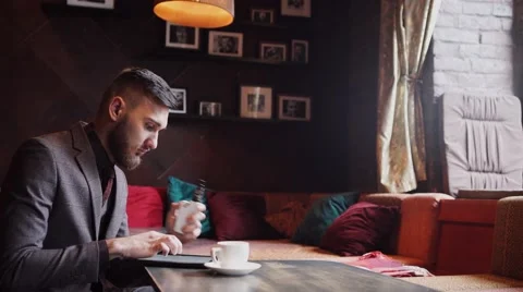 Man using an advanced personal e-cigarette and used tablet Stock Footage 57113681