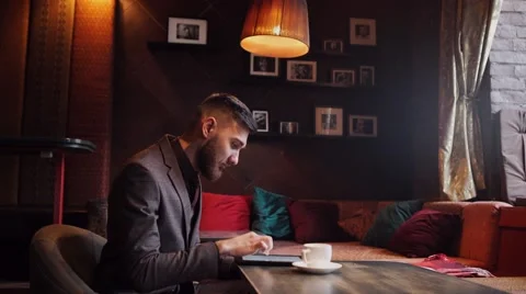 Man using an advanced personal e-cigarette and used tablet Stock Footage 57113851