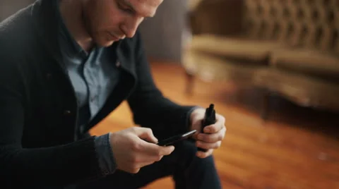 Man using an advanced personal vaporizer or e-cigarette Stock Footage 62051775