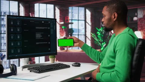 Man using AI chatbot to generate real time responses next to mockup display Stock Footage 307723537