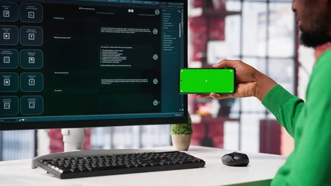 Man using AI chatbot to generate real time responses next to mockup display Stock Footage 307795282