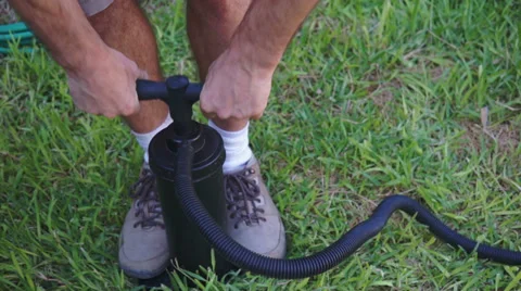 Man Using Air Pump on Grass 動画素材 39691235