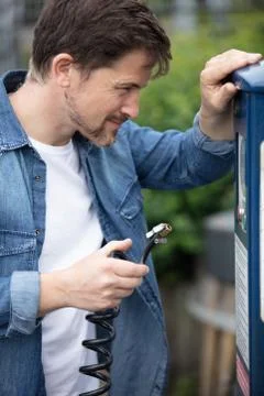 Man using air pump on tire Stock Photos