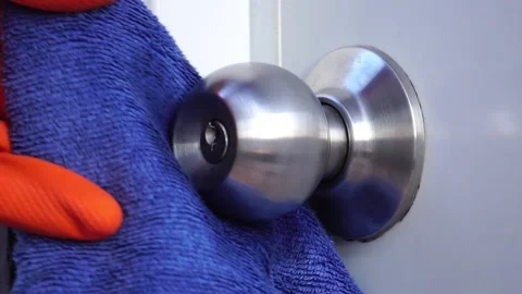 Man using alcohol based sanitizer spray on door knob Stock Footage 147868920