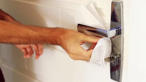 Man using alcohol gel to clean the door handle. Hygiene concept. Covid-19. Stock Footage 133600005