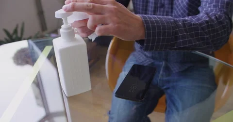 Man using alcohol sanitizer for cleaning and disinfect mobile phone screen in 스톡 동영상 132013499